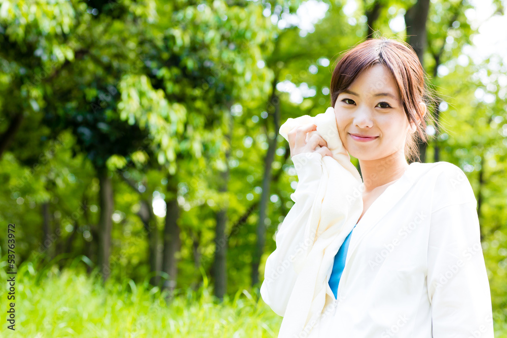 young asian woman relaxing in the park young asian woman relaxing in the park