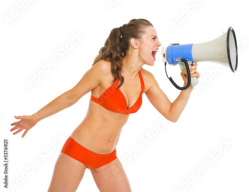 Young woman in swimsuit shouting through megaphone