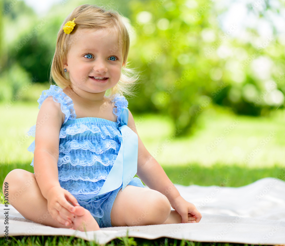Cute smiling little girl on grass