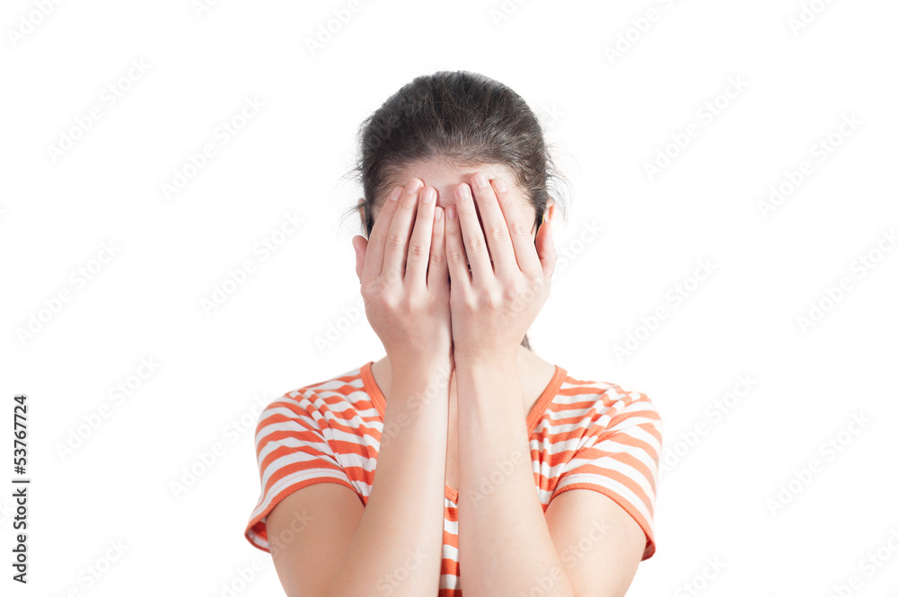 Young woman covers her face with hands Young woman covers her face with hands