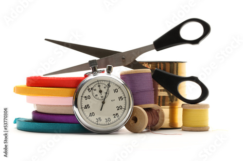 Thread bobbins, stopwatch, scissors and reels of ribbon