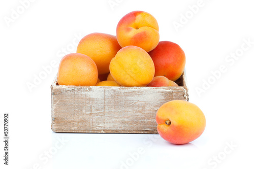 ripe apricots in wooden box, Isolated on white backgroun