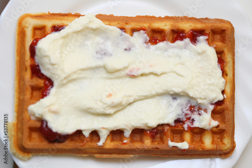 Belgian waffle with jam and whipped cream