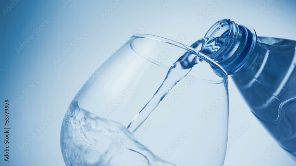 pouring water from a bottle into a glass pouring water from a bottle into a glass