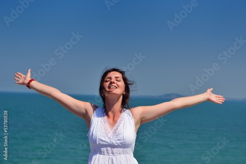 young woman with spreading arms to sky