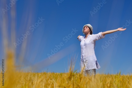 young woman with spreading arms to sky