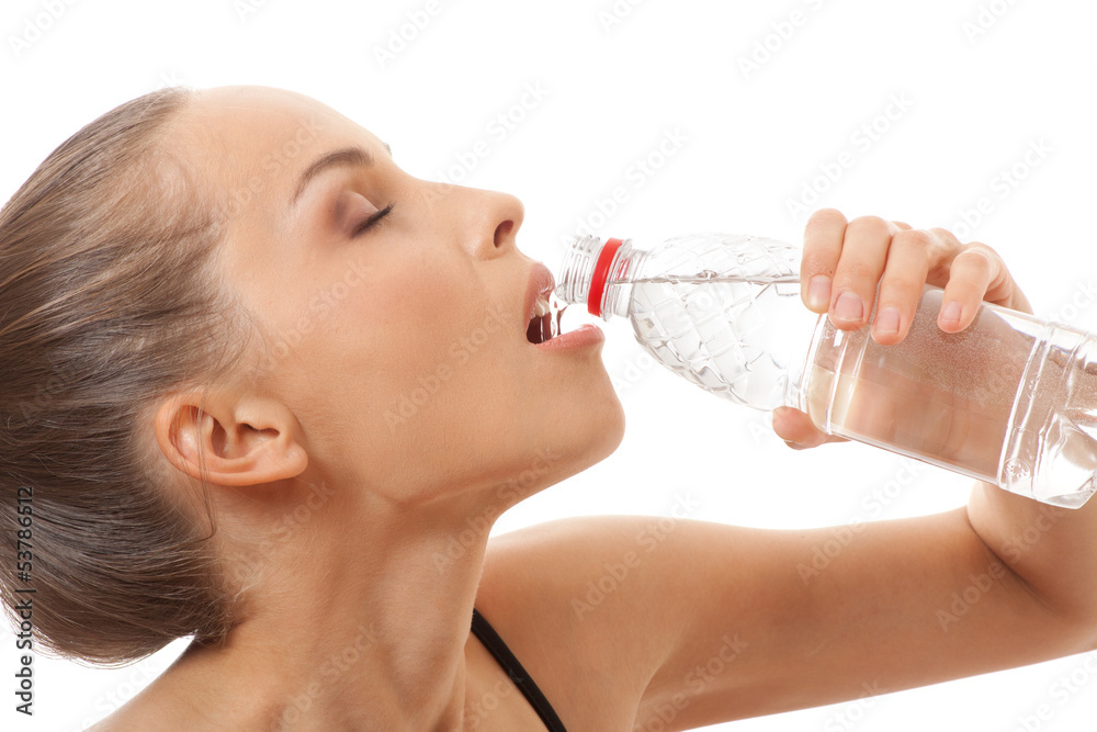Woman in fitness wear drinking water, isolated on white Woman in fitness wear drinking water, isolated on white