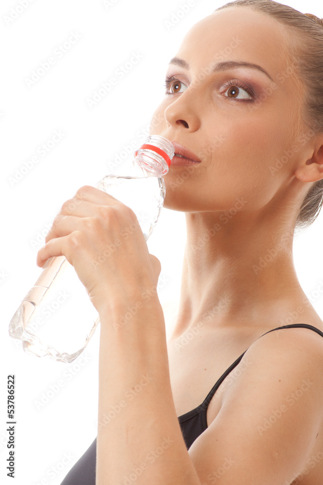 Woman in fitness wear drinking water, isolated on white Woman in fitness wear drinking water, isolated on white