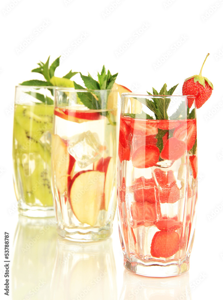 Glasses of fruit drinks with ice cubes isolated on white