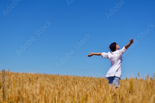 young woman with spreading arms to sky