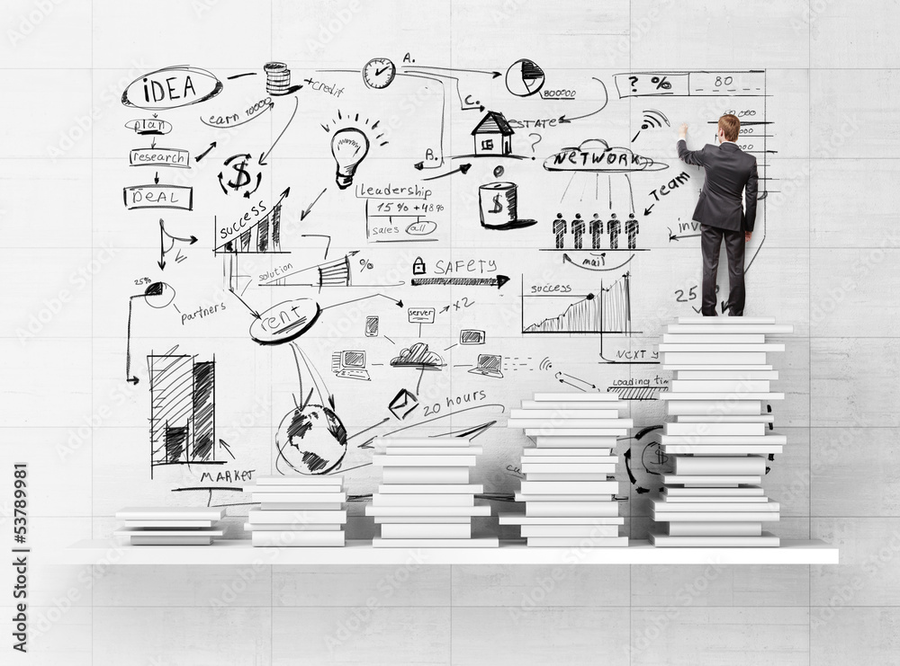 businessman standing on books and drawing strategy businessman standing on books and drawing strategy