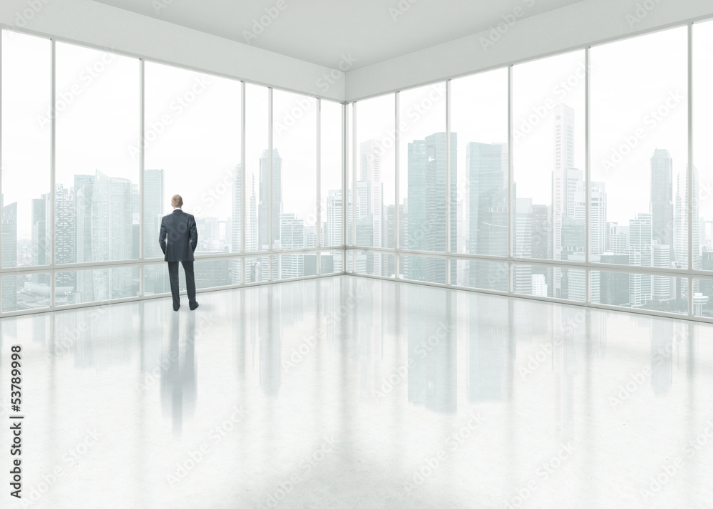 Businessman looking through the window Businessman looking through the window