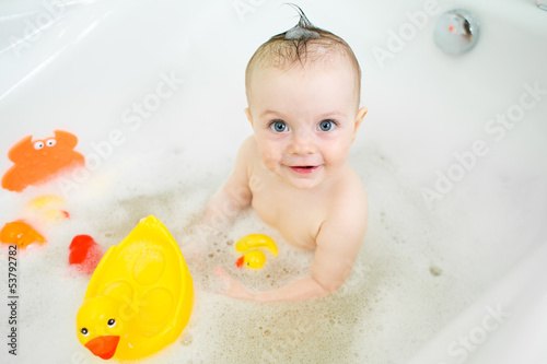 smiling baby girl taking ba...