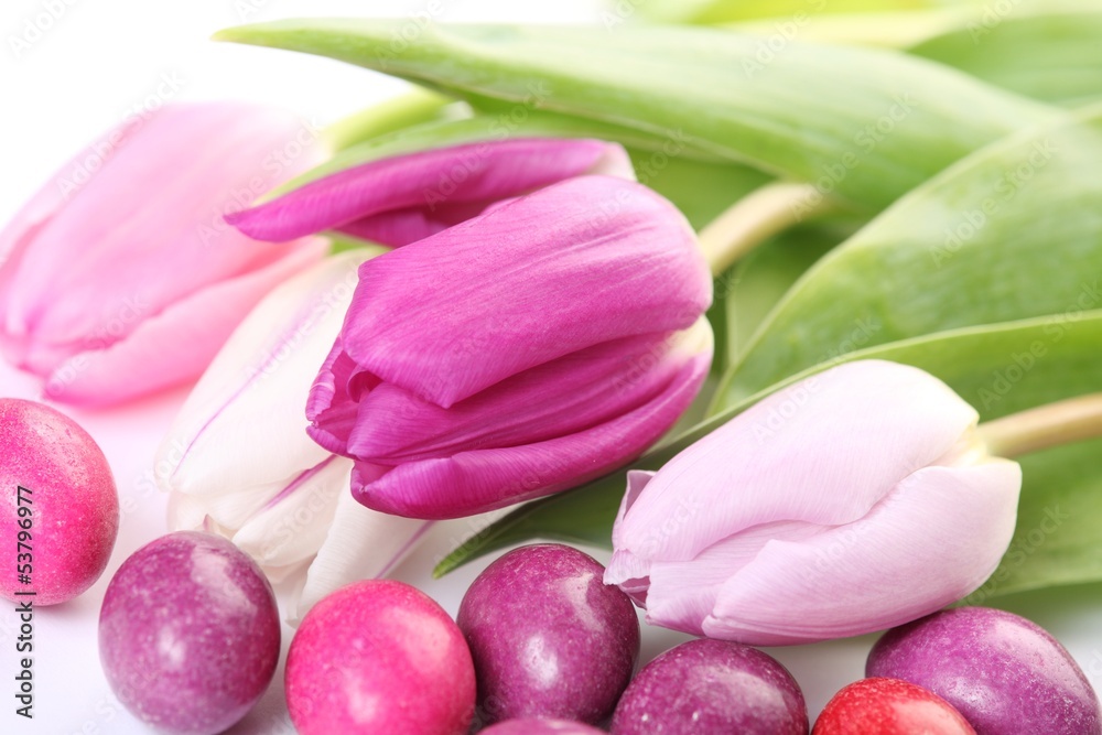Fototapeta premium Close-up of candy eggs and tulips