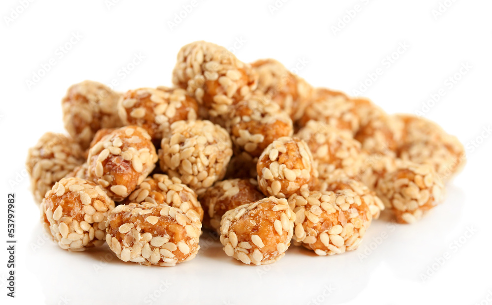 Tasty peanuts with sesame and caramel, isolated on white Tasty peanuts with sesame and caramel, isolated on white