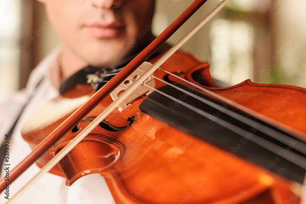 It sounds fascinating. Close up of men playing the violin It sounds fascinating. Close up of men playing the violin
