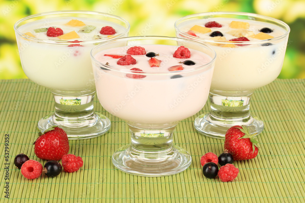 Delicious yogurt with fruit on table on bright background Delicious yogurt with fruit on table on bright background