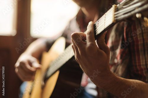 Creativity in focus. Close-up of men playing acoustic guitar