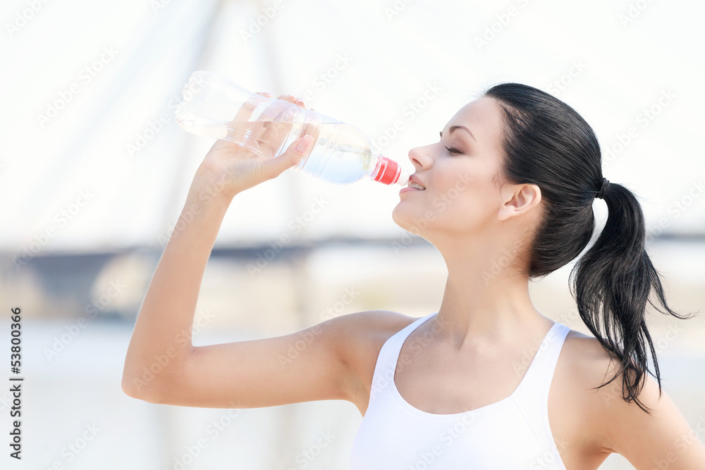 I need some water after training. Portrait of beautiful young wo I need some water after training. Portrait of beautiful young wo