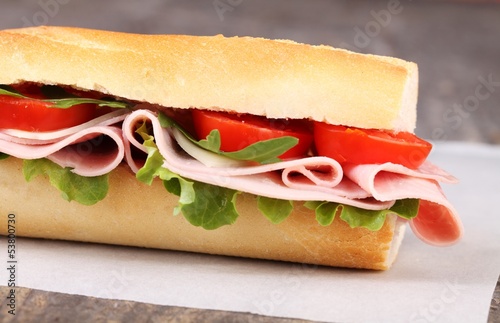 Baguette with ham, cheese, lettuce and tomatoes