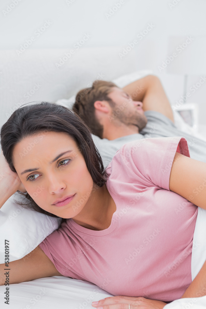 Thoughtful woman lying in her bed Thoughtful woman lying in her bed