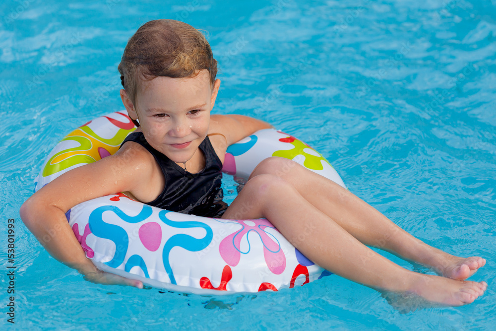little girl in the pool  with rubber ring