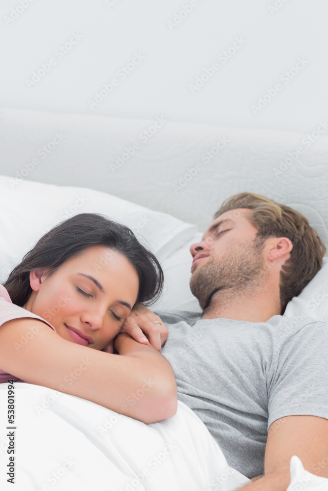 Pretty woman sleeping on her husbands chest Pretty woman sleeping on her husbands chest