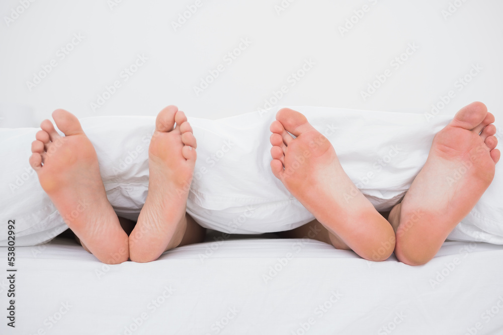 Feet of a couple in bed Feet of a couple in bed