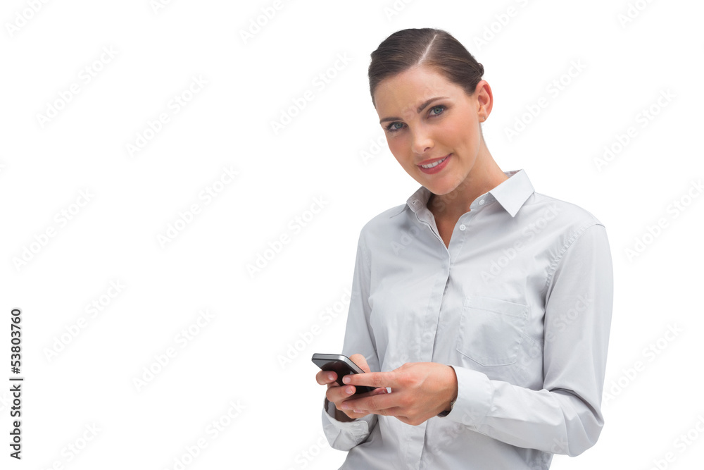 Smiling businesswoman sending text message Smiling businesswoman sending text message
