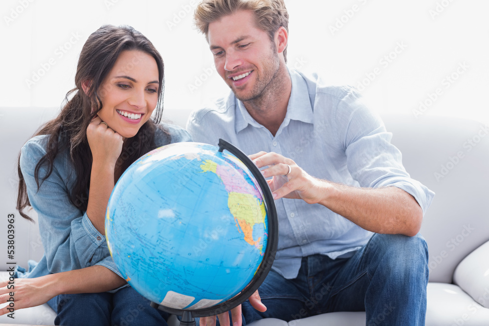 Couple looking at a globe Couple looking at a globe