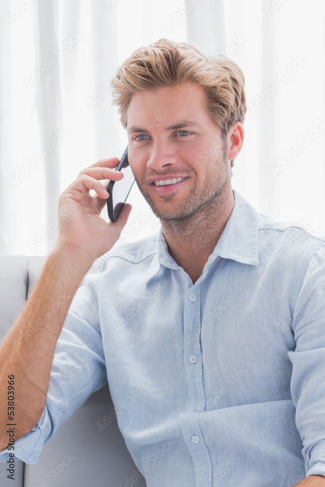 Man smiling while he is having a phone conversation Man smiling while he is having a phone conversation