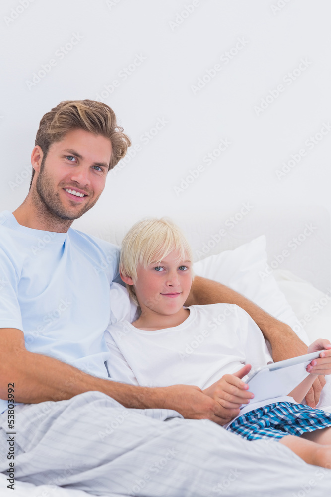 Handsome father and his son using a tablet Handsome father and his son using a tablet