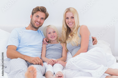 Portrait of a beautiful family in the bed