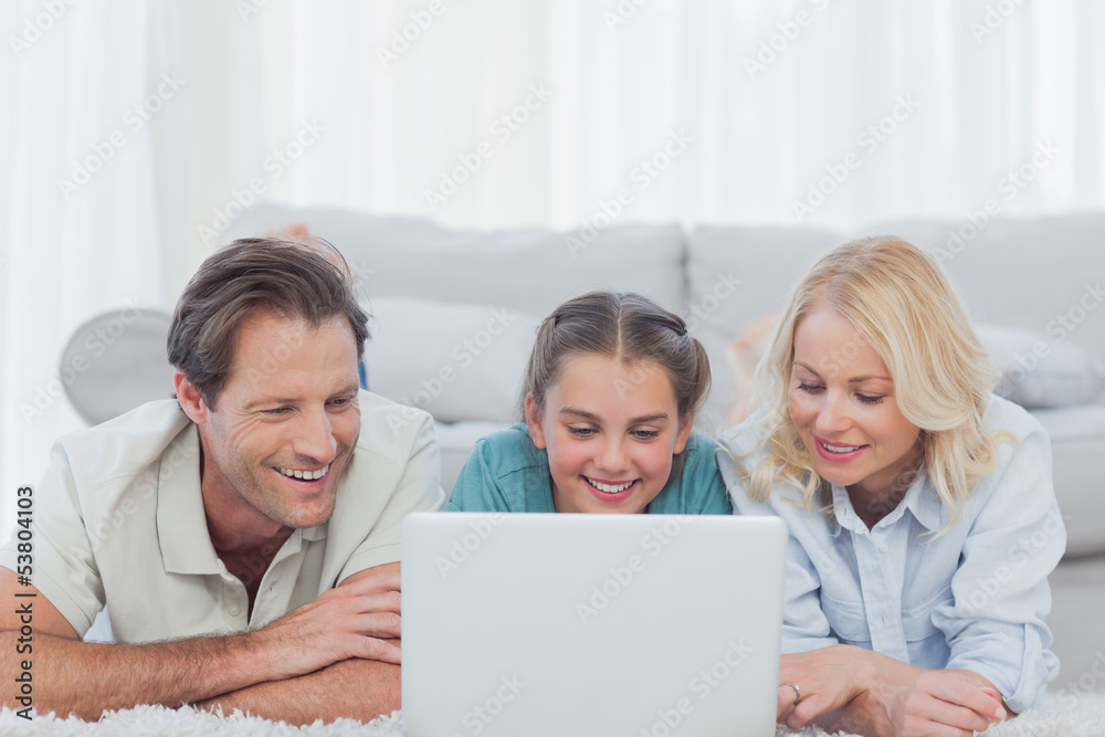 Parents and daughter using a laptop Parents and daughter using a laptop