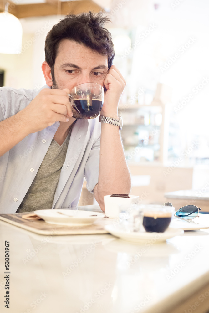 man at the bar drinking coffee man at the bar drinking coffee