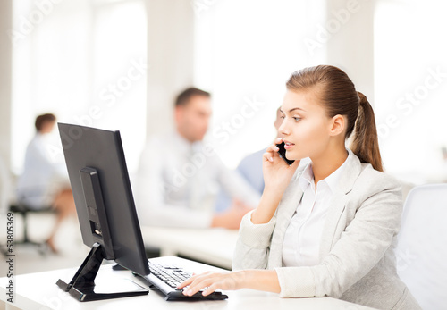 businesswoman with smartphone in office