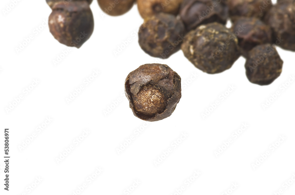 Beans of black pepper close up on white Beans of black pepper close up on white