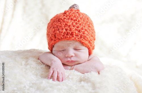 newborn in a cap pumpkin