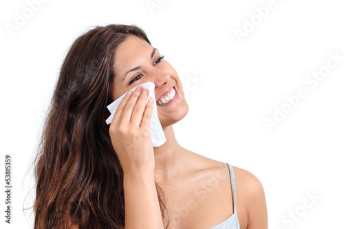 Attractive woman cleaning her face with a tissue