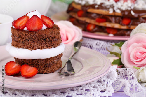 Chocolate cake with strawberry on wooden table close-up