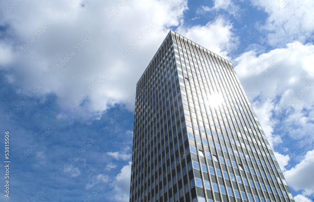 One Isolated Skyscraper with Blue Sky and Clouds One Isolated Skyscraper with Blue Sky and Clouds