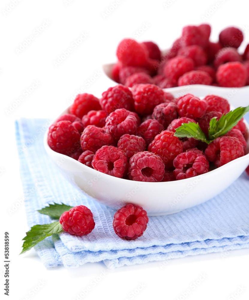 Ripe sweet raspberries in bowls, isolated on white Ripe sweet raspberries in bowls, isolated on white