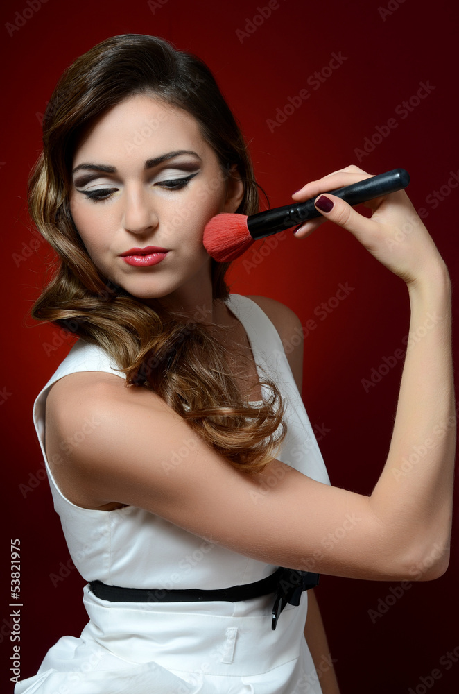 Fototapeta premium The beautiful girl with brushes make-up