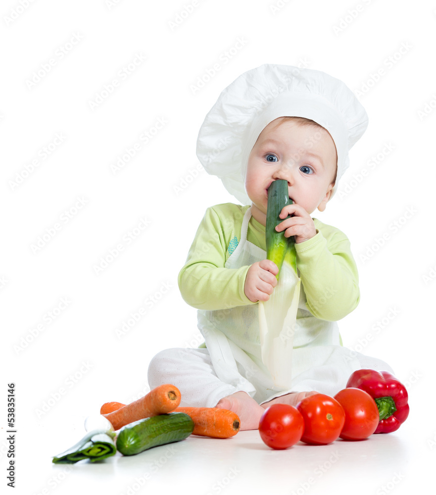 baby boy wearing a chef hat with healthy food vegetables baby boy wearing a chef hat with healthy food vegetables