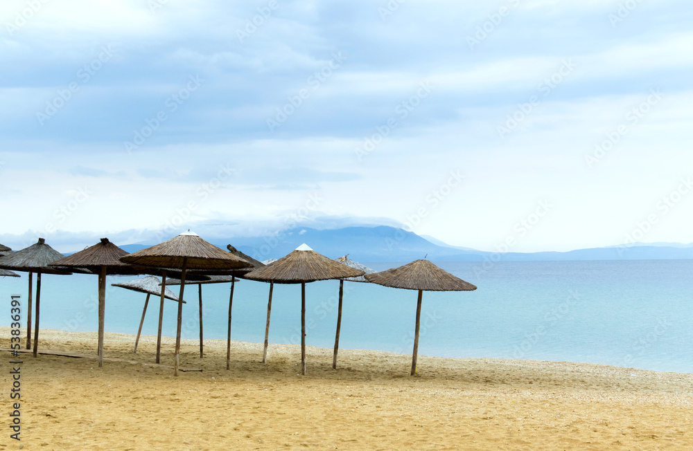 Sun loungers with an umbrella morning on the beach scene