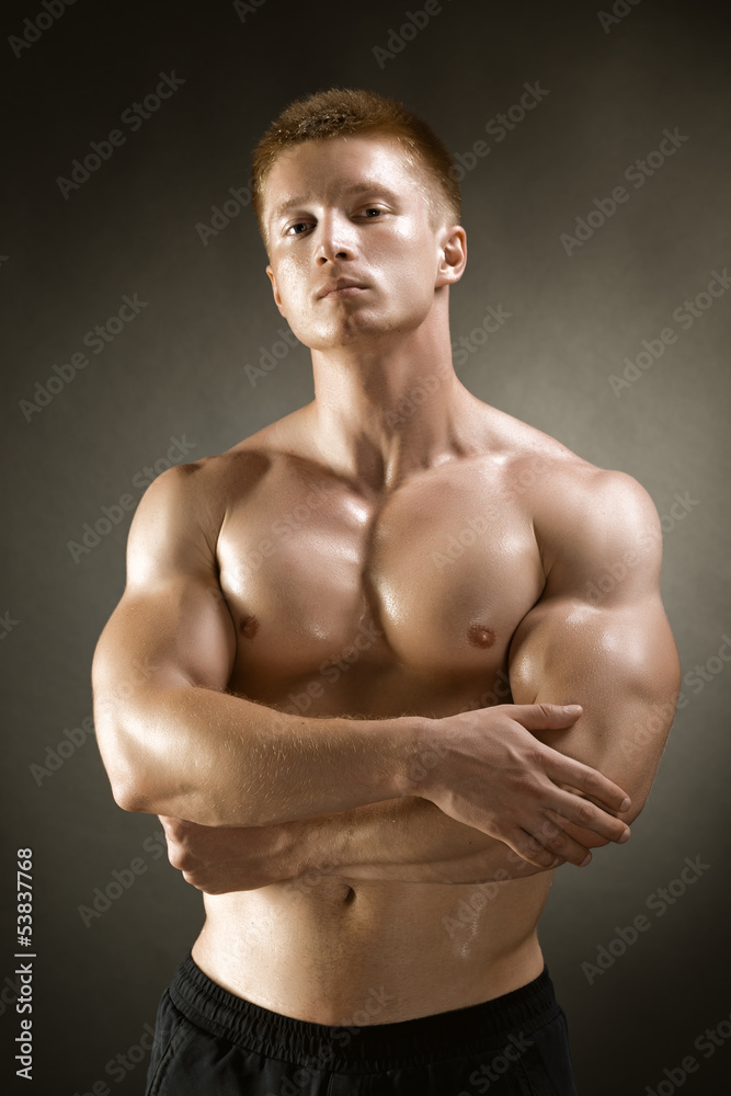 Healthy muscular young man posing in studio Healthy muscular young man posing in studio