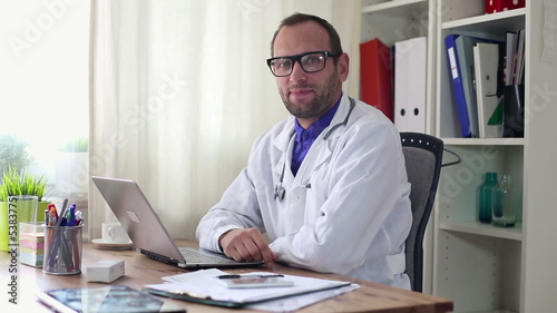Wallpaper Mural Friendly, happy male doctor in the office Torontodigital.ca