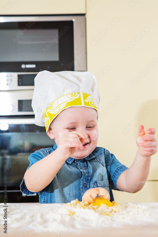 Child baking cupcakes in kitchen at home Child baking cupcakes in kitchen at home
