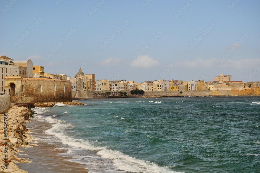 A beautiful panorama showing the beautiful old town of Trapani in  Sicily showing the golden old town walls and the blue sea and sky 