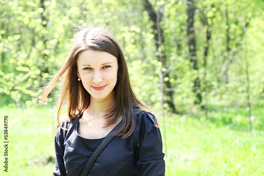 young beautiful smiling girl on a background of green vegetation young beautiful smiling girl on a background of green vegetation